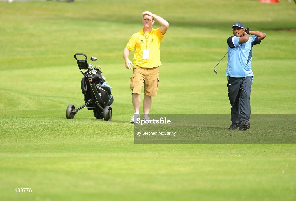 12 June 2010; Arun Ramalingam, from Harolds Cross, Dublin, and caddy Trevor Griffin, from Patrickswell, Dublin, keep an eye on his shot on the 18th during the Golf competition during the third day of the 2010 Special Olympics Ireland Games. Limerick Golf Club, Limerick. Picture credit: Stephen McCarthy / SPORTSFILE