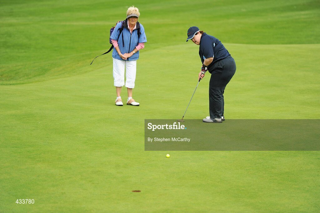 12 June 2010; Claire Savage, from Rathcoole, Dublin, putts on the 18th green alongside caddy Dympna Cotter, Celbridge, Co. Kildare, during the Golf event during the third day of the 2010 Special Olympics Ireland Games. Limerick Golf Club, Limerick. Picture credit: Stephen McCarthy / SPORTSFILE