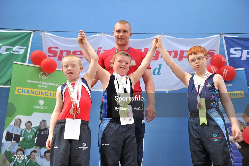 12 June 2010; Munster and Ireland rugby star Keith Earls after presenting medals for Vault to athetes, from left, Darren Coleman, from Thurles, Co. Tipperary, Darren Breen, from Malahide, Dublin, and Laurence McDermot, from Castleknock, Dublin, during the third day of the 2010 Special Olympics Ireland Games. University of Limerick, Limerick. Picture credit: Stephen McCarthy / SPORTSFILE