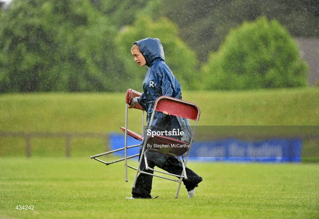 13 June 2010; Voulenteer Croidh Fitzgerald, from Newmarket, Clare, goes for cover during a downpour during the final day of the 2010 Special Olympics Ireland Games. University of Limerick, Limerick. Picture credit: Stephen McCarthy / SPORTSFILE