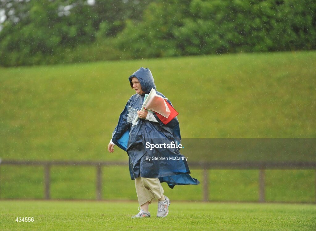 13 June 2010; Voulenteer Carmel Howard, from Shannon, Limerick, makes her way across the infield amid a shower of rain during the final day of the 2010 Special Olympics Ireland Games. University of Limerick, Limerick. Picture credit: Stephen McCarthy / SPORTSFILE