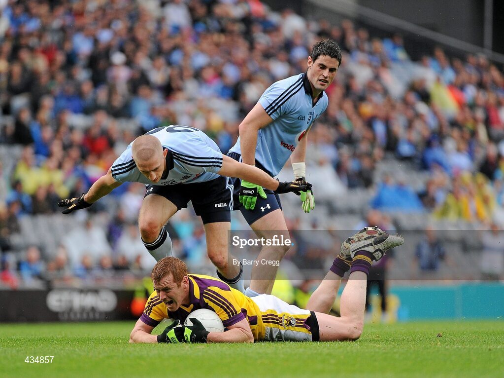 13 June 2010; Wexford's Eric Bradley is fouled by Dublin's Eoghan O' Gara as Ross McConnell looks on. Leinster GAA Football Senior Championship Quarter-Final, Dublin v Wexford, Croke Park, Dublin. Picture credit: Barry Cregg / SPORTSFILE
