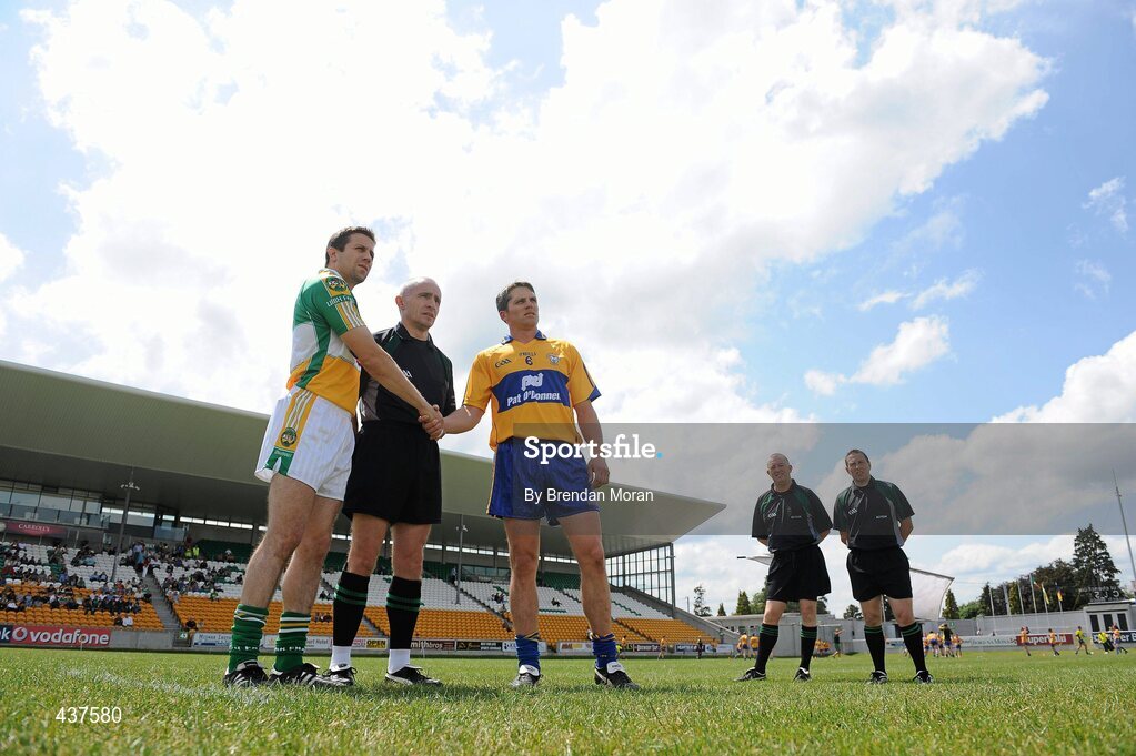 26 June 2010; Team captains Karol Slattery, left, Offaly, and Gordon Kelly, Clare, shake hands in front of referee Martin Higgins as linesmen Derek O'Mahony and Declan Hunt look on. GAA Football All-Ireland Senior Championship Qualifier Round 1, Offaly v Clare, O'Connor Park, Tullamore, Co. Offaly. Picture credit: Brendan Moran / SPORTSFILE