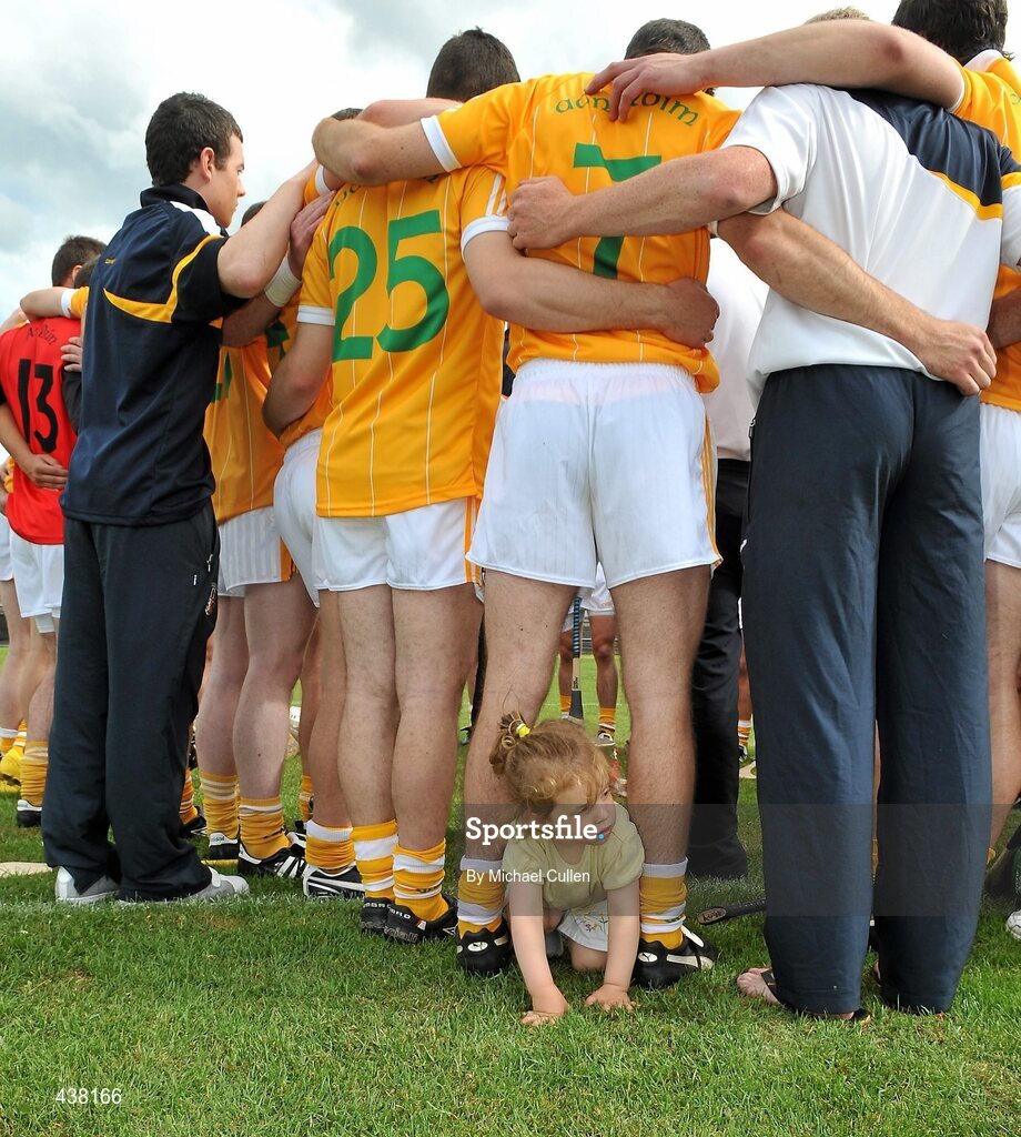27 June 2010; A young Antrim supporter gets involved in a team huddle. Ulster GAA Hurling Senior Championship Final, Antrim v Down, Casement Park, Belfast. Picture credit: Michael Cullen / SPORTSFILE