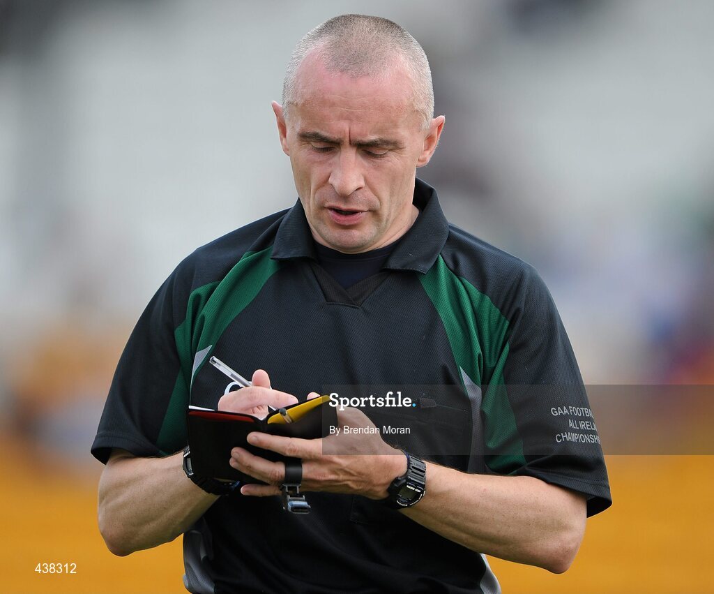26 June 2010; Referee Martin Higgins takes the name of a player during the game. GAA Football All-Ireland Senior Championship Qualifier Round 1, Offaly v Clare, O'Connor Park, Tullamore, Co. Offaly. Picture credit: Brendan Moran / SPORTSFILE