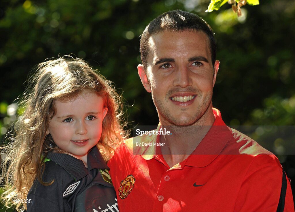 8 July 2010; Manchester United and Republic of Ireland International John O'Shea with Sophie Cooke, age 4, from Bray, Co. Wicklow, pictured at the ticket launch for the Airtricity Challenge on Wednesday August 4th when a representative Airtricity League XI takes on Manchester United at the Aviva Stadium. The Airtricity Challenge will be the first historic match in the new stadium. Portmarnock Hotel and Golf Links, Portmarnock, Co. Dublin. Picture credit: David Maher / SPORTSFILE