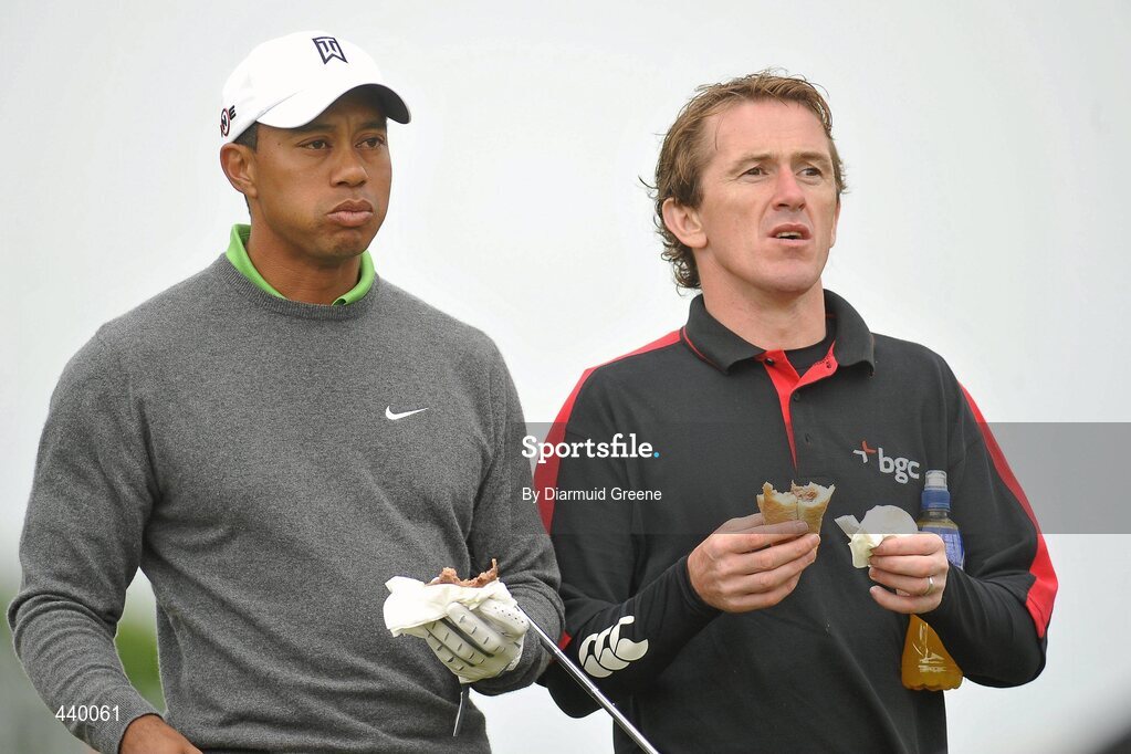 6 July 2010; Tiger Woods, left, and Tony McCoy enjoy a snack at the 6th tee box during the JP McManus Invitational Pro-Am. Adare Manor, Adare, Co. Limerick. Picture credit: Diarmuid Greene / SPORTSFILE