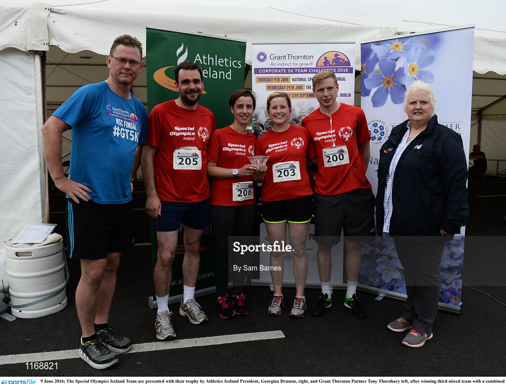 9 June 2016; The Special Olympics Ireland Team are presented with their trophy by Athletics Ireland President, Georgina Drumm, right, and Grant Thornton Partner Tony Thornbury left, after winning third mixed team with a combined time of 1:36:49 at the Grant Thornton Corporate 5K Team Challenge at the National Sports Campus in Abbotstown, Dublin. Photo by Sam Barnes/Sportsfile