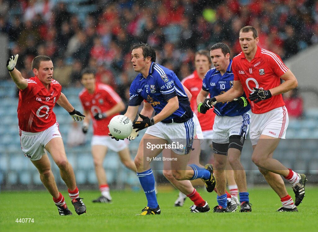 10 July 2010; John McCutcheon, Cavan, in action against Patrick Kelly and Pearse O'Neill, 11, Cork. GAA Football All-Ireland Senior Championship Qualifier, Round 2, Cork v Cavan, Pairc Ui Chaoimh, Cork.  Picture credit: Matt Browne / SPORTSFILE