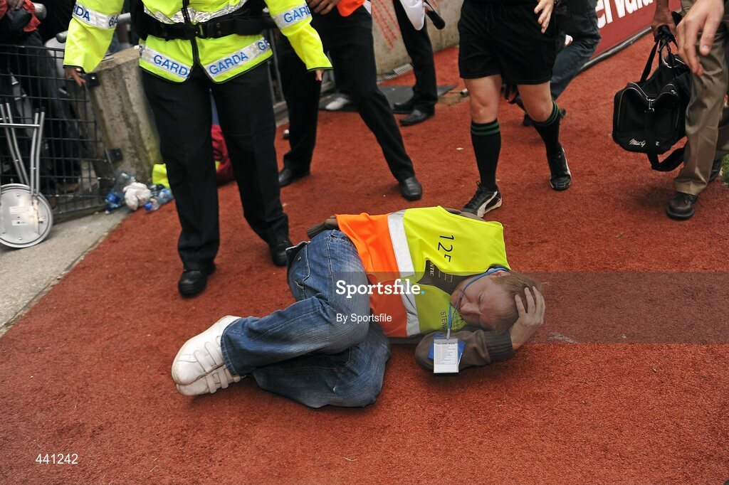 11 July 2010; A steward lies on the ground after being struck by a bottle. Leinster GAA Football Senior Championship Final, Meath v Louth, Croke Park, Dublin. Photo by Sportsfile