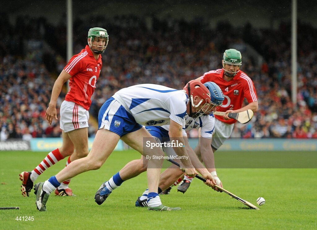 11 July 2010; Waterford team-mates John Mullane, left, and Shane Walsh compete for the silothar as Cork players Eoin Cadogan, left, and Brian Murphy watch on. Munster GAA Hurling Senior Championship Final, Cork v Waterford, Semple Stadium, Thurles, Co. Tipperary. Picture credit: Stephen McCarthy / SPORTSFILE