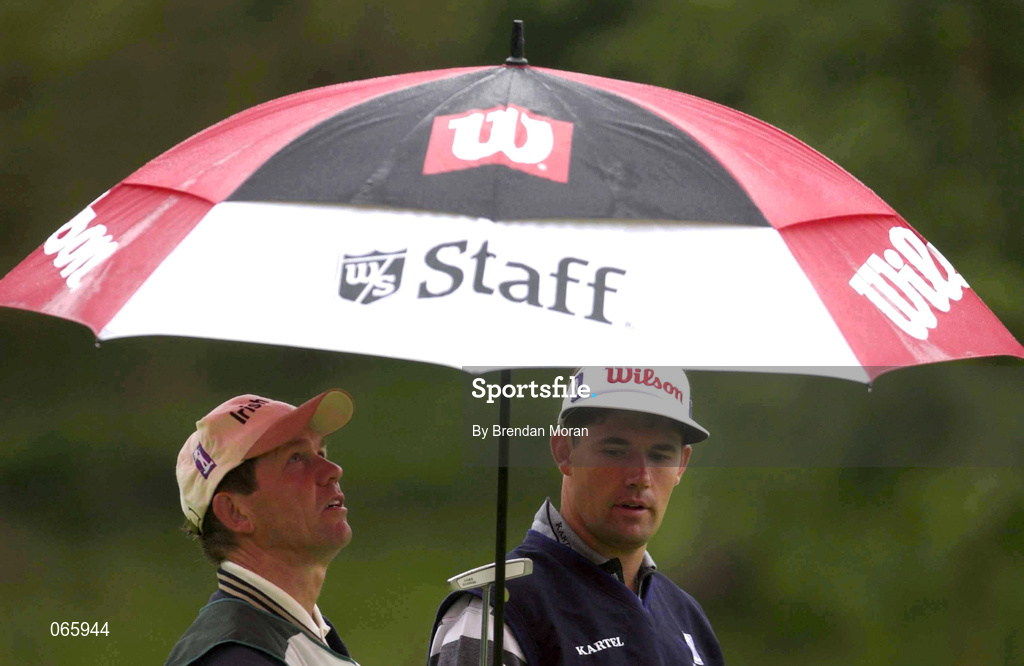 28 June 2001; Padraig Harrington of Ireland shelters from the rain with his caddy during day one of the Murphy's Irish Open at Fota Island Golf Club in Cork. Photo by Brendan Moran/Sportsfile