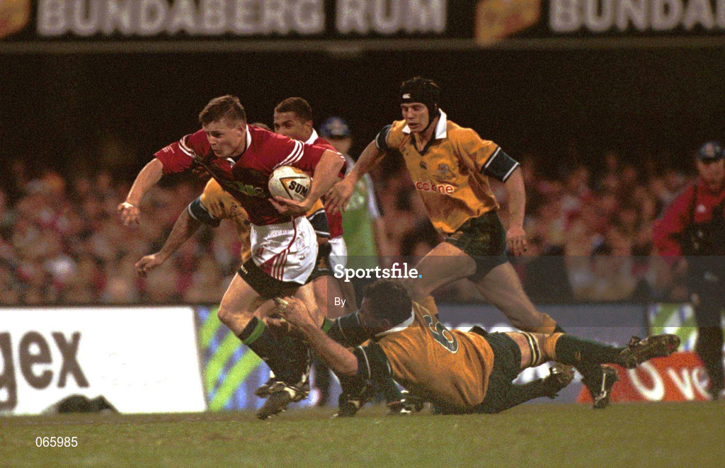 30 June 2001; Brian O'Driscoll, British and Irish Lions, is tackled by Owen Finegan, Australia. Australia v British and Irish Lions, Gabba Stadium, Brisbane, Queensland, Australia. Rugby. Picture credit; Matt Browne / SPORTSFILE