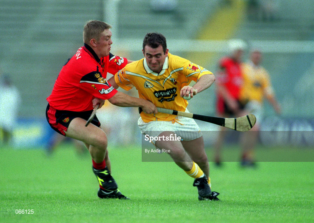 1 July 2001; Alastair Elliot of Antrim is tackled by Jerome Trainor of Down during the Bank of Ireland Ulster Senior Football Championship Semi-Final match between Antrim and Down at Casement Park in Belfast. Photo by Aoife Rice/Sportsfile