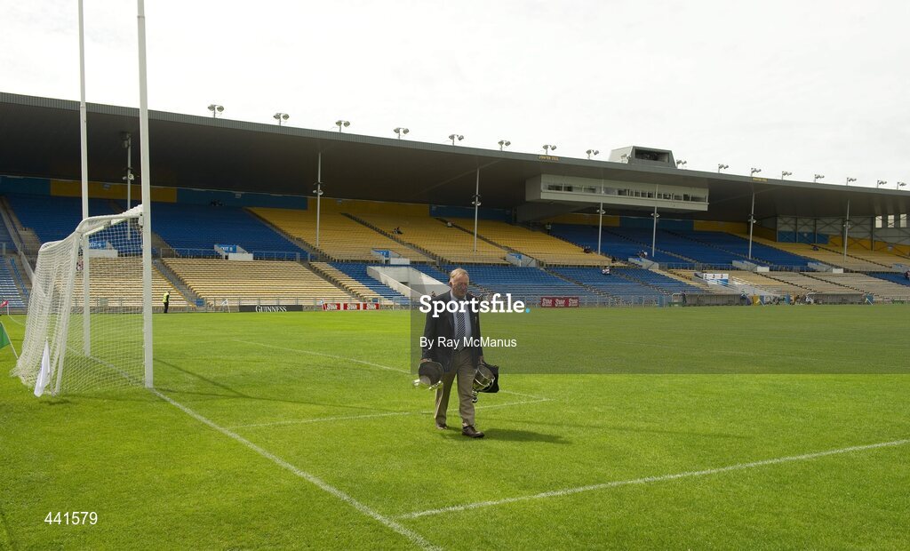 11 July 2010; Munster PRO Jim Forbes walks across the pitch with both the Minor and Senior Cups. Munster GAA Hurling Senior Championship Final, Cork v Waterford, Semple Stadium, Thurles, Co. Tipperary. Picture credit: Ray McManus / SPORTSFILE