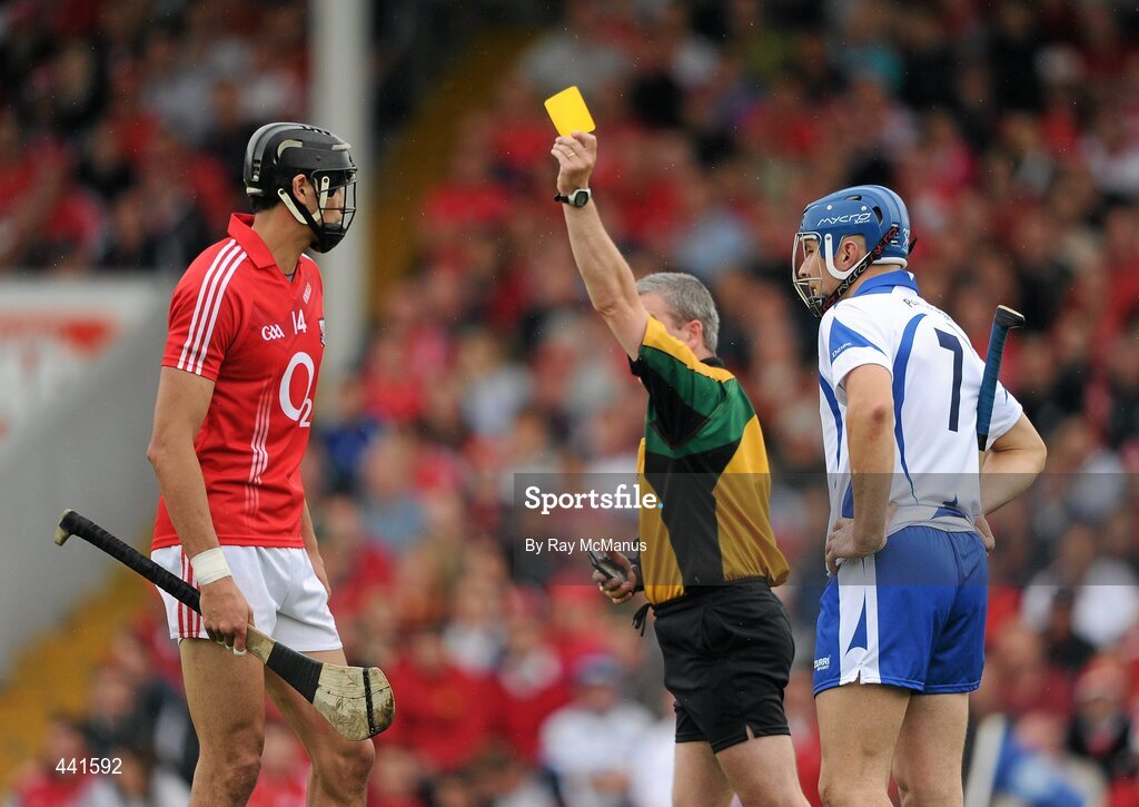 11 July 2010; Aisake Ó hÁilpín, Cork, and Declan Prendergast, Waterford, are both shown a yellow card by referee Johnny Ryan. Munster GAA Hurling Senior Championship Final, Cork v Waterford, Semple Stadium, Thurles, Co. Tipperary. Picture credit: Ray McManus / SPORTSFILE