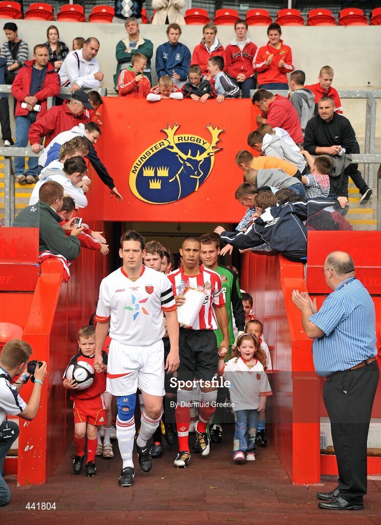 13 July 2010; Munster XI captain Pat Purcell, left, and Sunderland captain Anton Ferdinand lead their side's out before the game. Friendly in Aid of Shane Geoghegan Trust, Munster XI v Sunderland AFC, Thomond Park, Limerick. Picture credit: Diarmuid Greene / SPORTSFILE