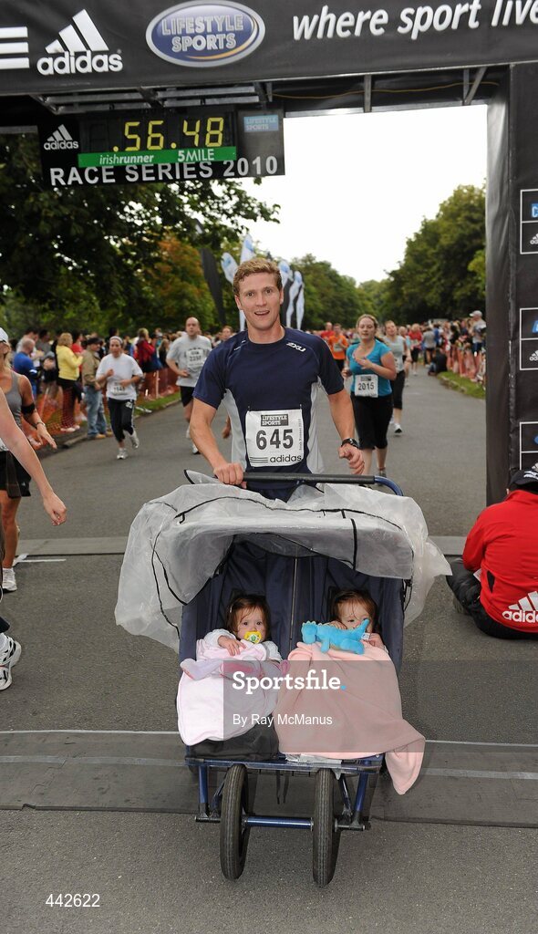 17 July 2010; Conor Duggan, from Rathfarnham, Dublin, finishes the Lifestyle Sports - adidas Irish Runner 5 Mile Race with one-year-old Abi and Erin. The Phoenix Park, Dublin. Picture credit: Ray McManus / SPORTSFILE