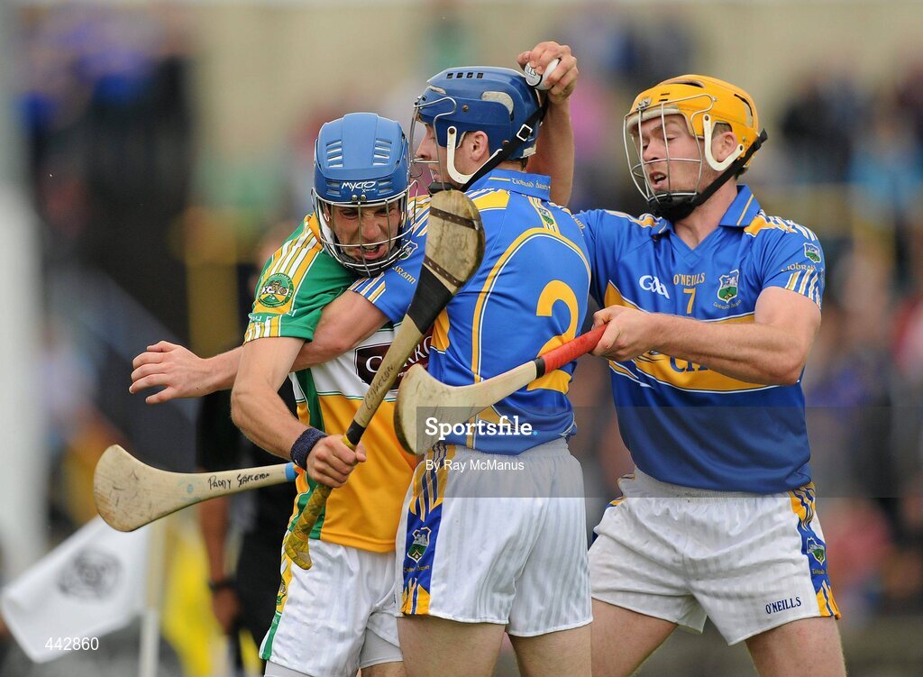 18 July 2010; Cathal Parlon, Offaly, retains the sliothar under pressure from Tipperary defenders Paddy Stapleton, 2, and Padraic Maher. GAA Hurling All-Ireland Senior Championship Phase 3, Tipperary v Offaly, O'Moore Park, Portlaoise, Co. Laois. Picture credit: Ray McManus / SPORTSFILE