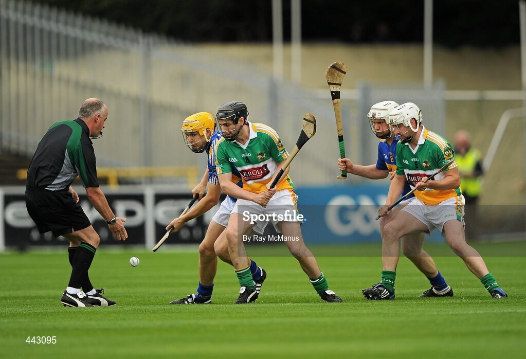 18 July 2010; Referee John Sexton throws in the sliothar between David Young, Tipperary, Brendan Murphy, Offaly, and Brendan Maher, Tipperary, and Dylan Hayden, Offaly. The game started five minutes late to facilitate the late arrival of some supporters. GAA Hurling All-Ireland Senior Championship Phase 3, Tipperary v Offaly, O'Moore Park, Portlaoise, Co. Laois. Picture credit: Ray McManus / SPORTSFILE