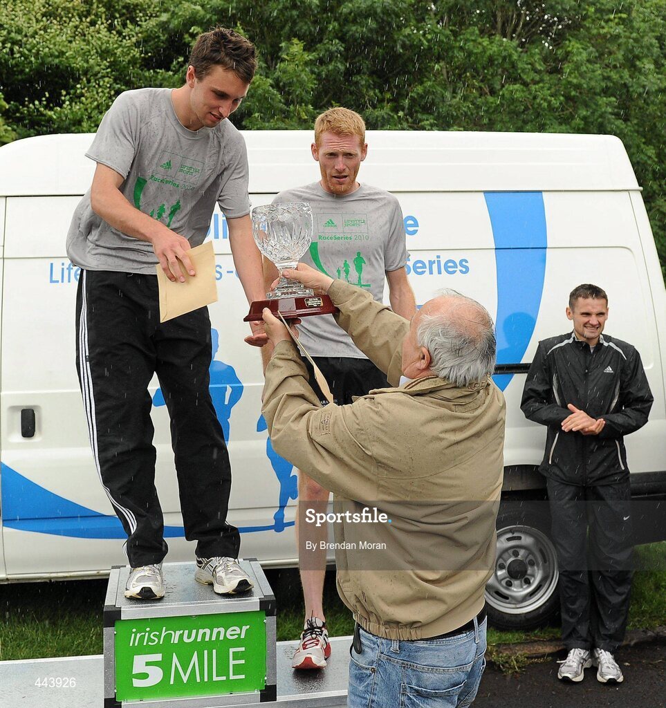 17 July 2010; Winner John Coghlan, Metro St Brigid's AC, receives his trophy from Frank Greally, Editor of Irish Runner, in the company of second placed Brian Maher, Kilkenny City Harriers AC, at the Lifestyle Sports - adidas Irish Runner 5 Mile Race. The Phoenix Park, Dublin. Picture credit: Brendan Moran / SPORTSFILE