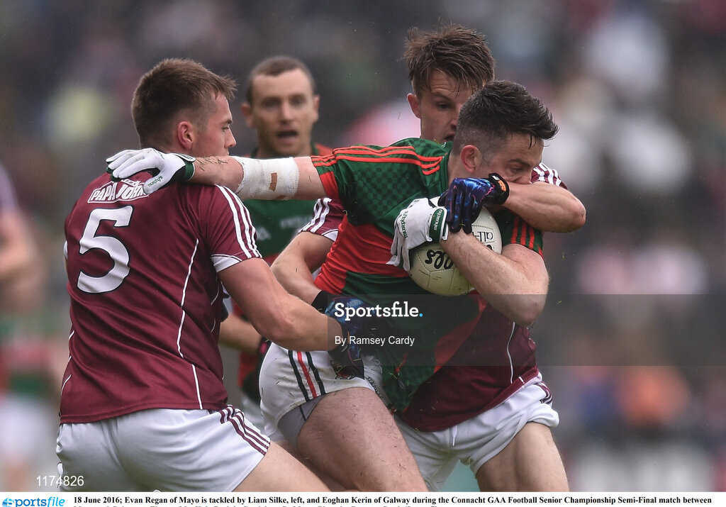 18 June 2016; Evan Regan of Mayo is tackled by Liam Silke, left, and Eoghan Kerin of Galway during the Connacht GAA Football Senior Championship Semi-Final match between Mayo and Galway at Elverys MacHale Park in Castlebar, Co Mayo. Photo by Ramsey Cardy/Sportsfile