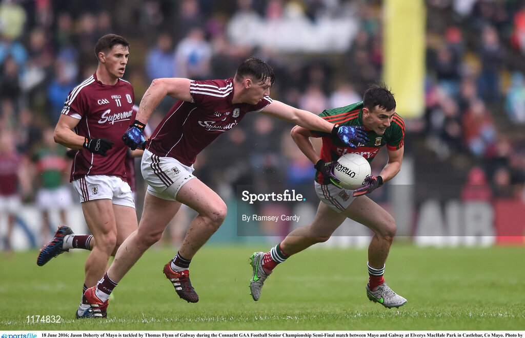 18 June 2016; Jason Doherty of Mayo is tackled by Thomas Flynn of Galway during the Connacht GAA Football Senior Championship Semi-Final match between Mayo and Galway at Elverys MacHale Park in Castlebar, Co Mayo. Photo by Ramsey Cardy/Sportsfile