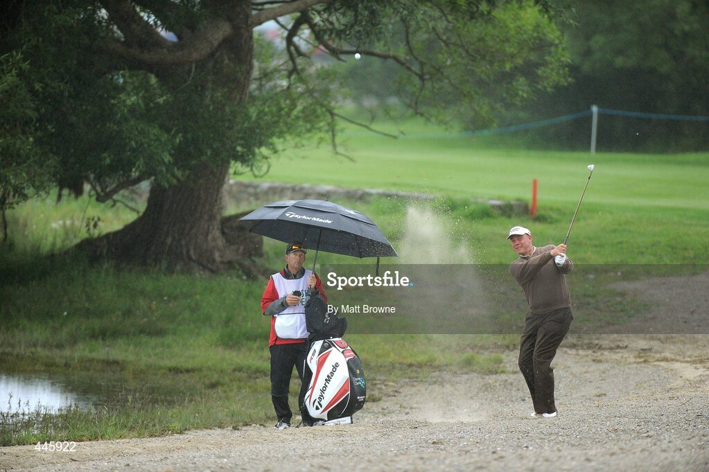 28 July 2010; Darren Clarke, watched by his caddy Brendan McCartan, plays from the sand trap on the first fairway . 3 Irish Open Golf Championship - Pro Am, Killeen Course, Killarney Golf & Fishing Club, Killarney, Co. Kerry. Picture credit: Matt Browne / SPORTSFILE