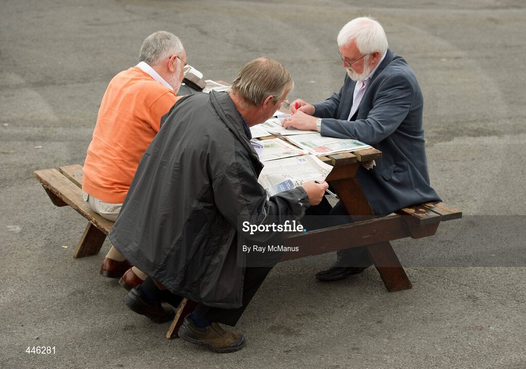29 July 2010; Three punters try and pick a winner before racing. Galway Racing Festival 2010, Ballybrit, Galway. Picture credit: Ray McManus / SPORTSFILE