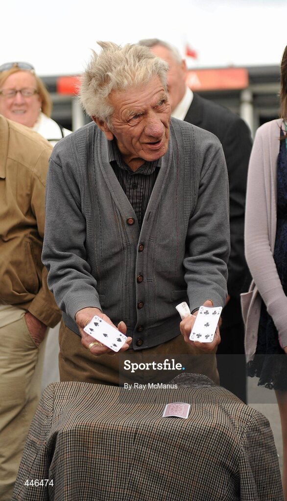29 July 2010; A gentleman operates a 'Three Card Trick' stand before being moved on by a member of An Garda Siochana. Galway Racing Festival 2010, Ballybrit, Galway. Picture credit: Ray McManus / SPORTSFILE