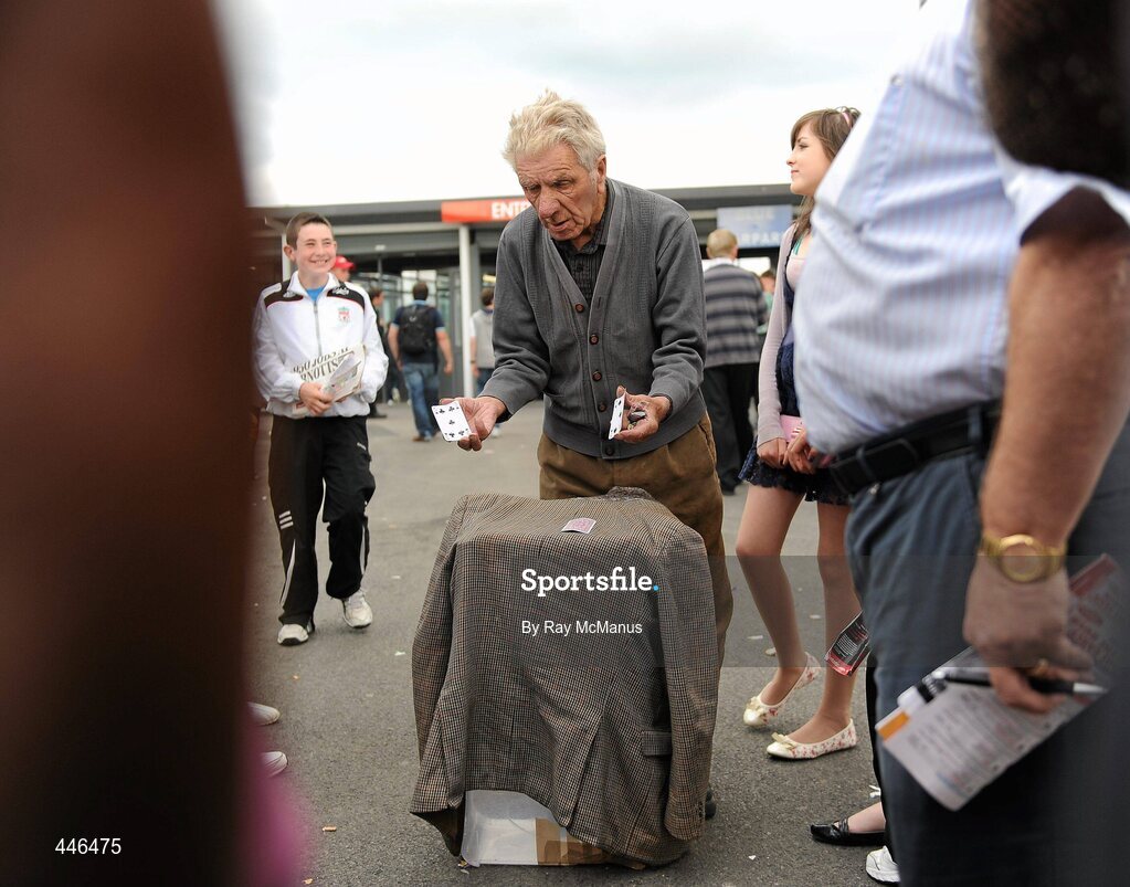 29 July 2010; A gentleman operates a 'Three Card Trick' stand before being moved on by a member of An Garda Siochana. Galway Racing Festival 2010, Ballybrit, Galway. Picture credit: Ray McManus / SPORTSFILE