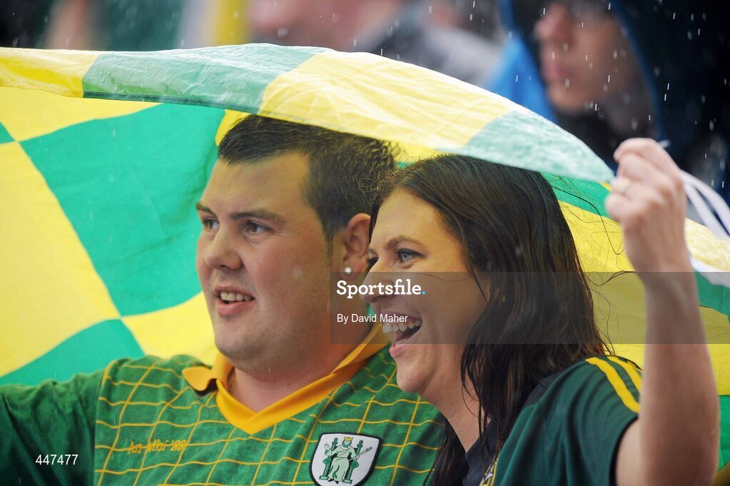 1 August 2010; Two Meath supporters shelter from the rain during the game. Supporters at the GAA Football All-Ireland Senior Championship Quarter-Finals, Croke Park, Dublin. Picture credit: David Maher / SPORTSFILE
