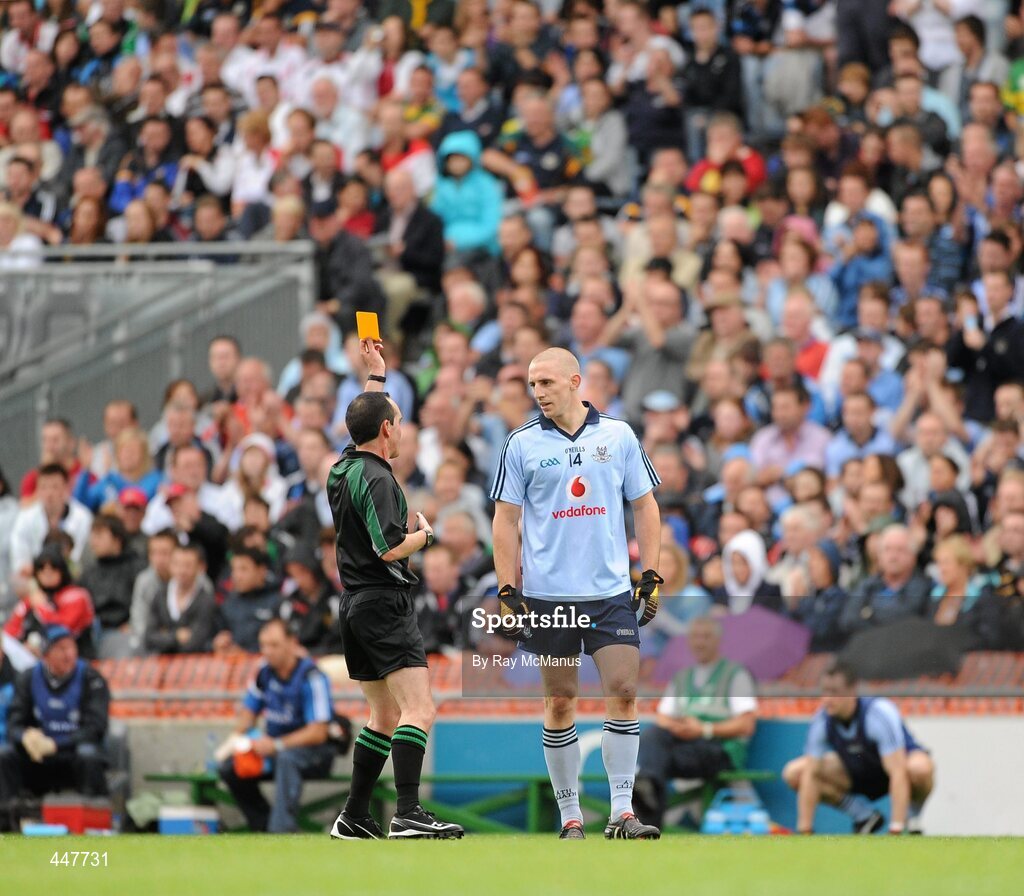 31 July 2010; Eoghan O'Gara, Dublin, is issued with a yellow card by referee David Goldrick. GAA Football All-Ireland Senior Championship Quarter-Final, Tyrone v Dublin, Croke Park, Dublin. Picture credit: Ray McManus / SPORTSFILE