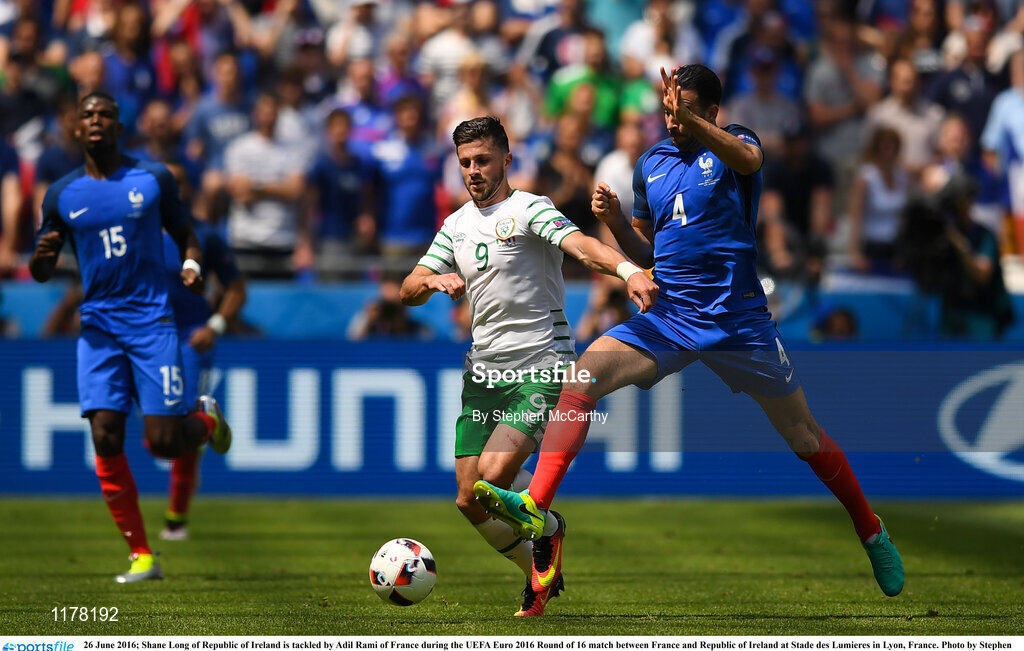 26 June 2016; Shane Long of Republic of Ireland is tackled by Adil Rami of France during the UEFA Euro 2016 Round of 16 match between France and Republic of Ireland at Stade des Lumieres in Lyon, France. Photo by Stephen McCarthy/Sportsfile