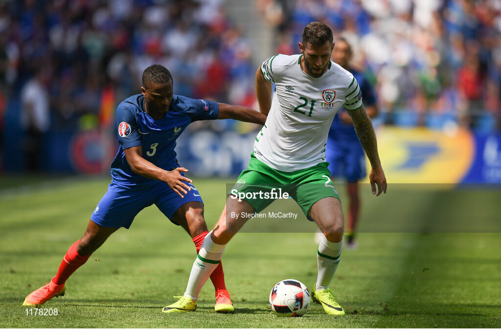 26 June 2016; Daryl Murphy of Republic of Ireland shields the ball from Patrice Evra of France during the UEFA Euro 2016 Round of 16 match between France and Republic of Ireland at Stade des Lumieres in Lyon, France. Photo by Stephen McCarthy/Sportsfile