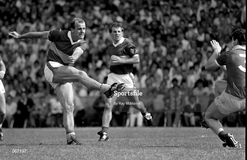 26 July 1987; Jack O'Shea of Kerry shoots for goal despite the efforts of Colman Corrigan of Cork during the Munster Senior Football Championship Final between Cork and Kerry at Páirc Ui Chaoimh in Cork. Photo by Ray McManus/Sportsfile