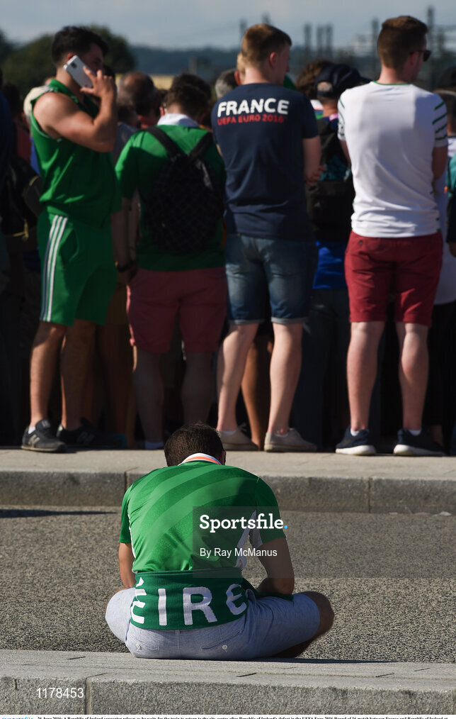 26 June 2016; A Republic of Ireland supporter relaxes as he waits for the train to return to the city centre after Republic of Ireland's defeat in the UEFA Euro 2016 Round of 16 match between France and Republic of Ireland at Stade des Lumieres in Lyon, France. Photo by Ray McManus/Sportsfile