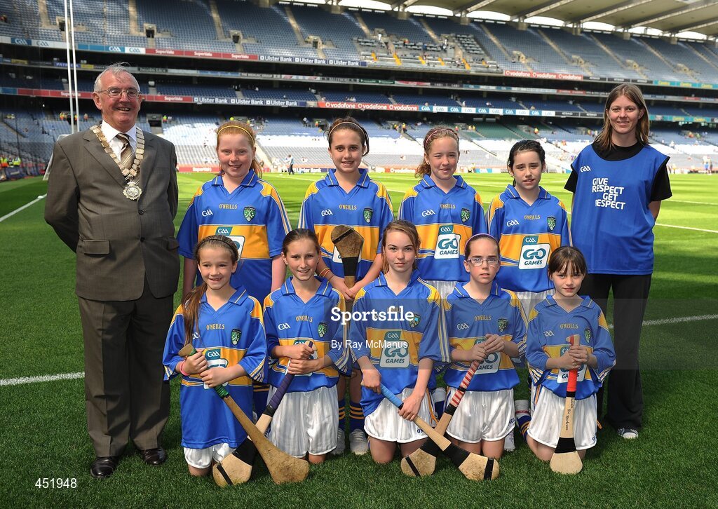 15 August 2010; President of the INTO Jim Higgins with the Tipperary camogie team, which included; Rebecca Farrell, St. Felim’s, The Vale, Co. Cavan, Eileen Cullen, Castleblaney G.N.S., Co. Monaghan, Arlene Leonard, Castleblaney, Co. Monaghan, Eimear Higgins, St. Columban’s P.S., Belcoo, Co. Fermanagh, Megan Kinney, St. Mary’s P.S., Bellanleck, Co. Fermanagh, Leanne Donnelly, Roan P.S., Eglish, Co. Tyrone, Roisín Nic Fhirleinn, St. Mary’s P.S., Pomeroy, Co. Tyrone, Andrea Tobin, Chreachmhaoil S.N., Craughwell, Co. Galway, Helen Furey, Labane N.S., Ardrahan, Co. Galway, Charlotte Nolan, St. Mary Magdalen’s P.S., Willesden, London. GAA Into Mini-Sevens during half time of the GAA Hurling All-Ireland Senior Championship Semi-Final, Waterford v Tipperary, Croke Park, Dublin. Picture credit: Ray McManus / SPORTSFILE