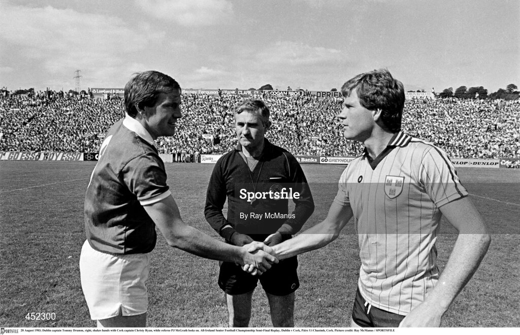 28 August 1983; Dublin captain Tommy Drumm, right, shakes hands with Cork captain Christy Ryan, while referee PJ McGrath looks on. All-Ireland Senior Football Championship Semi-Final Replay, Dublin v Cork, Páirc Uí Chaoimh, Cork. Picture credit: Ray McManus / SPORTSFILE