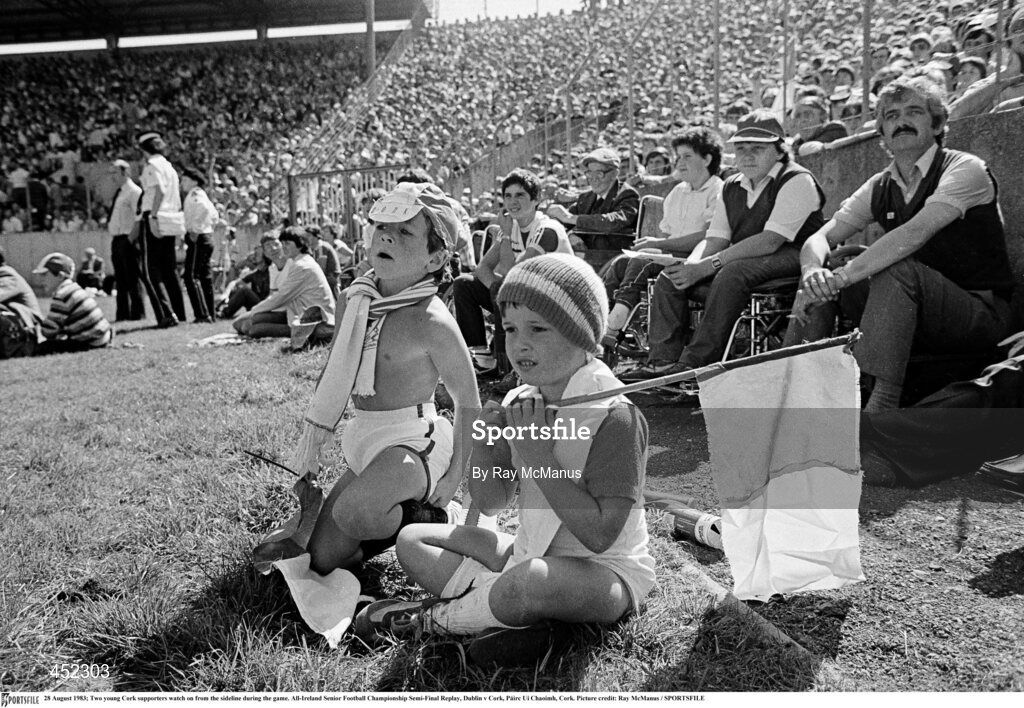 28 August 1983; Two young Cork supporters watch on from the sideline during the game. All-Ireland Senior Football Championship Semi-Final Replay, Dublin v Cork, Páirc Uí Chaoimh, Cork. Picture credit: Ray McManus / SPORTSFILE