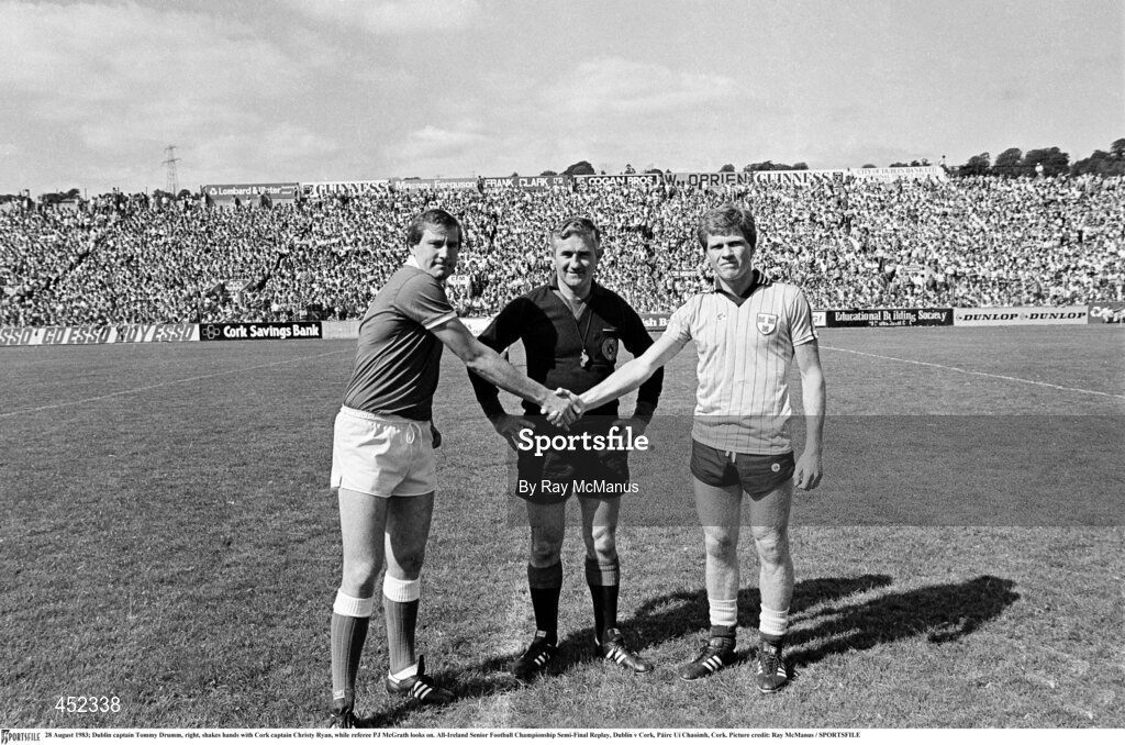28 August 1983; Dublin captain Tommy Drumm, right, shakes hands with Cork captain Christy Ryan, while referee PJ McGrath looks on. All-Ireland Senior Football Championship Semi-Final Replay, Dublin v Cork, Páirc Uí Chaoimh, Cork. Picture credit: Ray McManus / SPORTSFILE