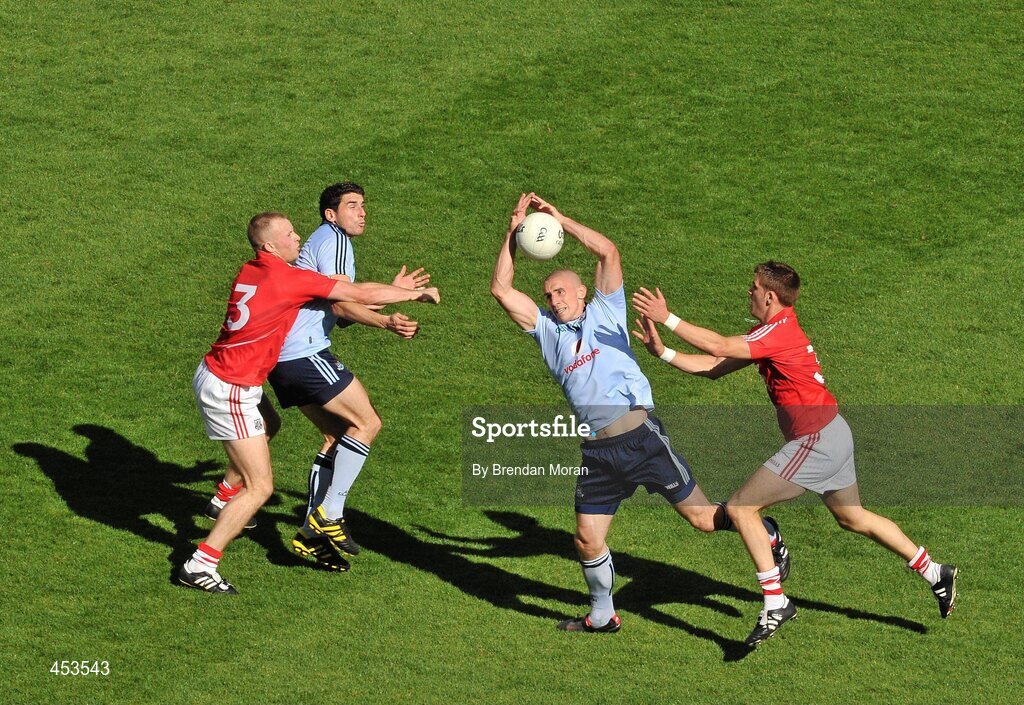 22 August 2010; Eoghan O'Gara, Dublin, catches a ball ahead of team-mate Bernard Brogan and Cork players Michael Shields, left, and Eoin Cadogan. GAA Football All-Ireland Senior Championship Semi-Final, Dublin v Cork, Croke Park, Dublin. Picture credit: Brendan Moran / SPORTSFILE