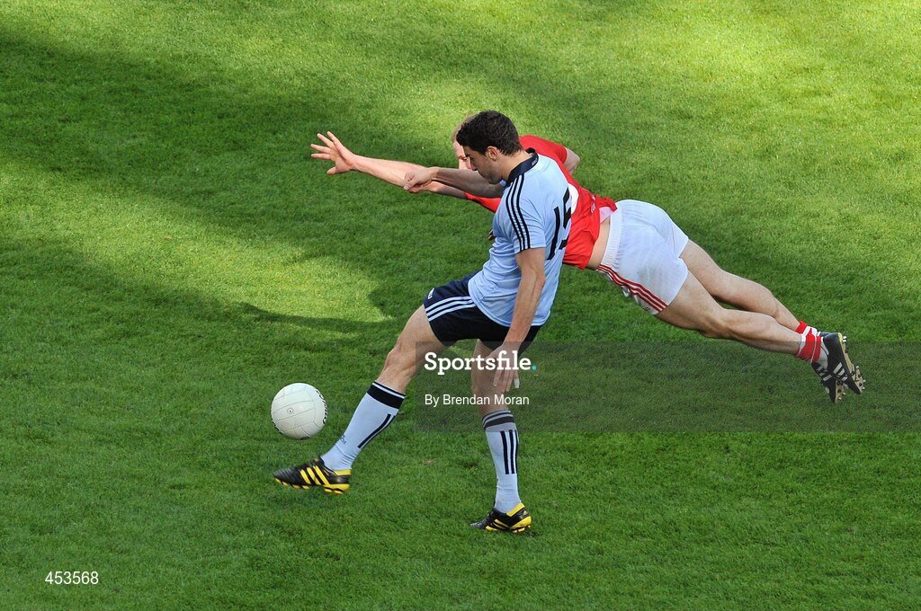 22 August 2010; Bernard Brogan, Dublin, kicks a point despite the best efforts of Michael Shields, Cork. GAA Football All-Ireland Senior Championship Semi-Final, Dublin v Cork, Croke Park, Dublin. Picture credit: Brendan Moran / SPORTSFILE
