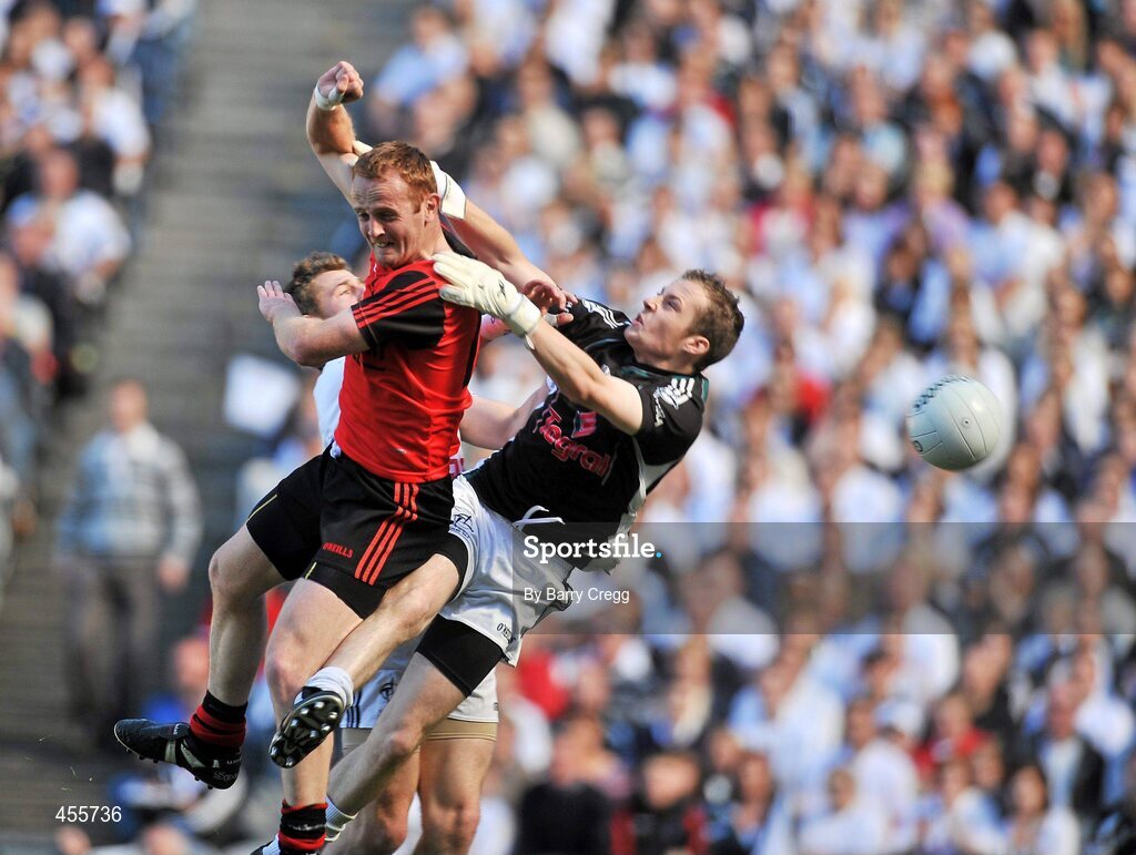 29 August 2010; Brendan Coulter, centre, Down, fists the ball past Emmet Bolton, left, Kildare and Shane McCormack, to score his side's first goal. GAA Football All-Ireland Senior Championship Semi-Final, Kildare v Down, Croke Park, Dublin. Picture credit: Barry Cregg / SPORTSFILE