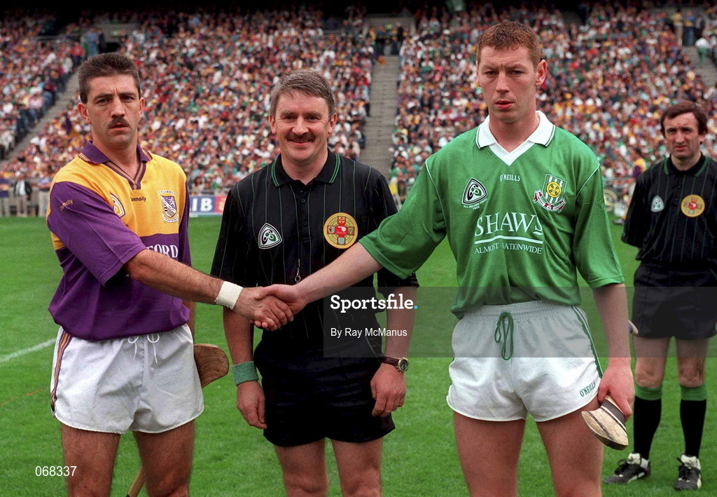 1 September 1996; Wexford captain Martin Storey shakes hands with Ciaran Carey of Limerick with referee Pat Horan ahead of the Guinness All-Ireland Senior Hurling Championship Final match between Wexford and Limerick at Croke Park in Dublin. Photo by Ray McManus/Sportsfile