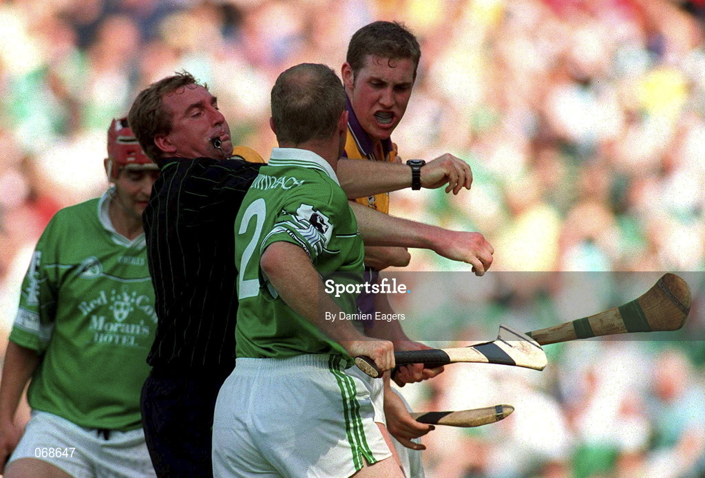29 July 2001; Referee Michael Wadding separates Nicky Lambert of Wexford and Stephen McDonagh of Limerick during the Guinness All-Ireland Senior Hurling Championship Quarter-Final match between Wexford and Limerick at Croke Park in Dublin. Photo by Damien Eagers/Sportsfile