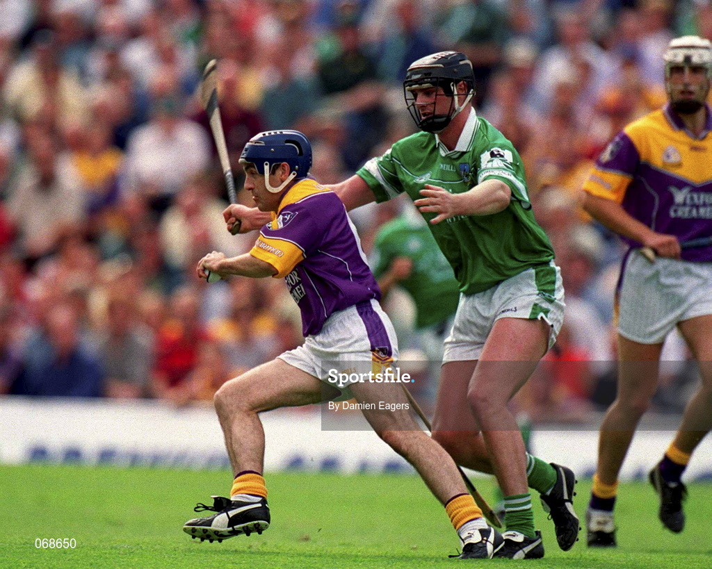 29 July 2001; Liam Dunne of Wexford in action against Brian Begley of Limerick during the Guinness All-Ireland Senior Hurling Championship Quarter-Final match between Wexford and Limerick at Croke Park in Dublin. Photo by Damien Eagers/Sportsfile