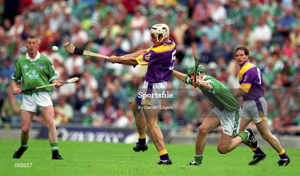 29 July 2001; Declan Ruth of Wexford clears downfield from Mike O'Brien of Limerick during the Guinness All-Ireland Senior Hurling Championship Quarter-Final match between Wexford and Limerick at Croke Park in Dublin. Photo by Damien Eagers/Sportsfile