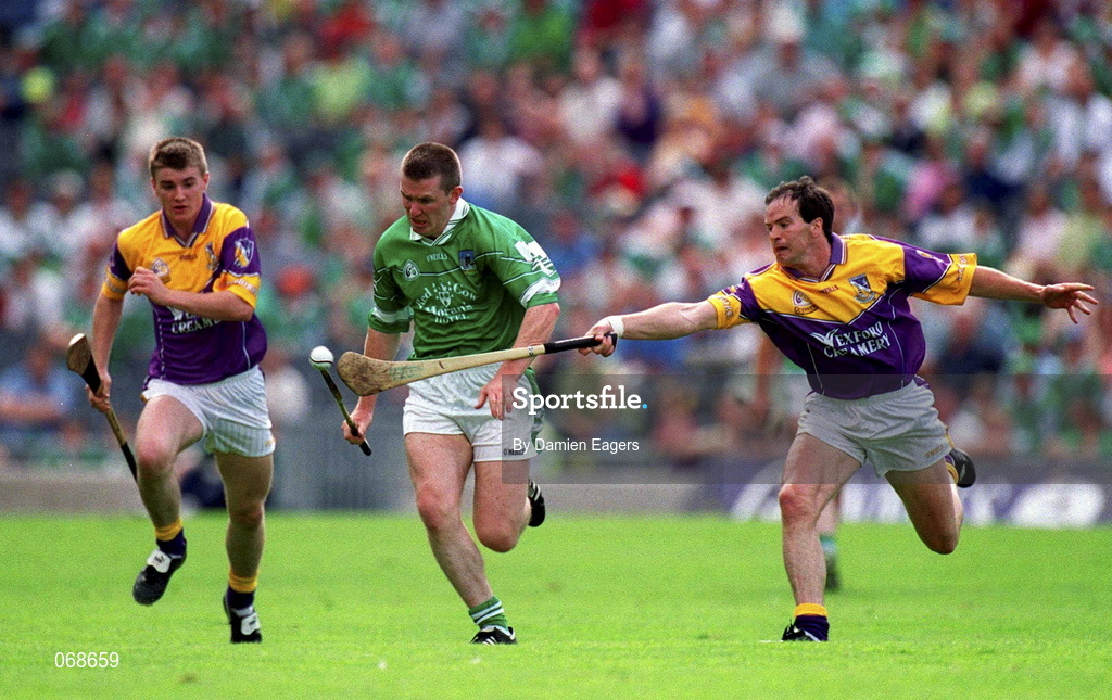 29 July 2001; Mark Foley of Limerick attempts to get away from Adrian Fenlon of Wexford during the Guinness All-Ireland Senior Hurling Championship Quarter-Final match between Wexford and Limerick at Croke Park in Dublin. Photo by Damien Eagers/Sportsfile