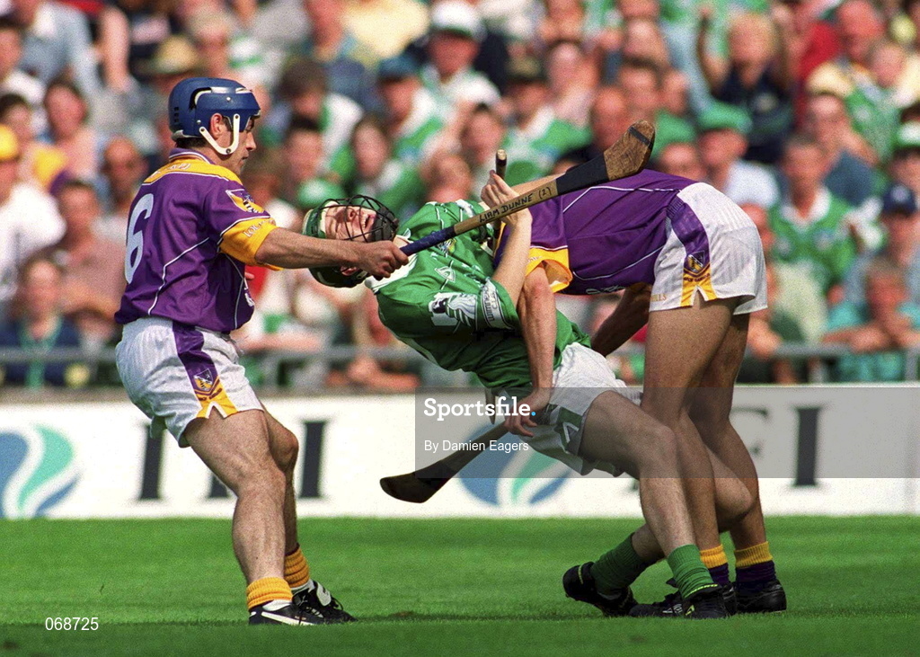 29 July 2001; Sean O'Connor of Limerick is tackled by Declan Ruth, right, and Liam Dunne of Wexford during the Guinness All-Ireland Senior Hurling Championship Quarter-Final match between Wexford and Limerick at Croke Park in Dublin. Photo by Damien Eagers/Sportsfile